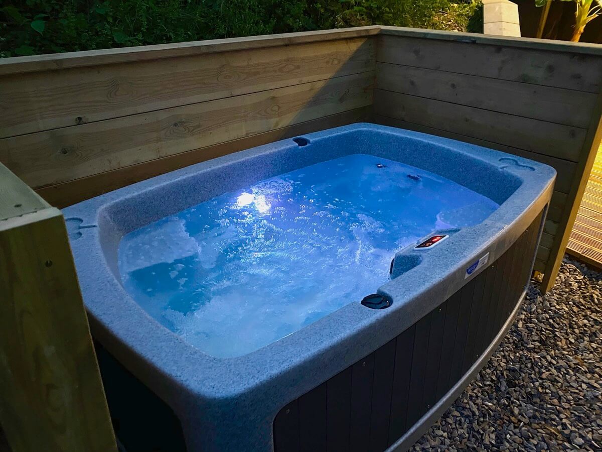 Sunridge cubes hot tub, bubbling at night.