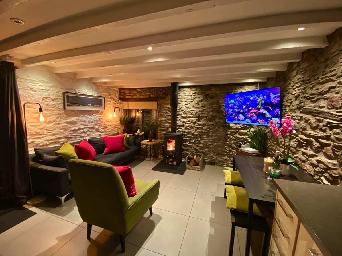 A large, flat-screen TV in a cozy living room, Devon, UK