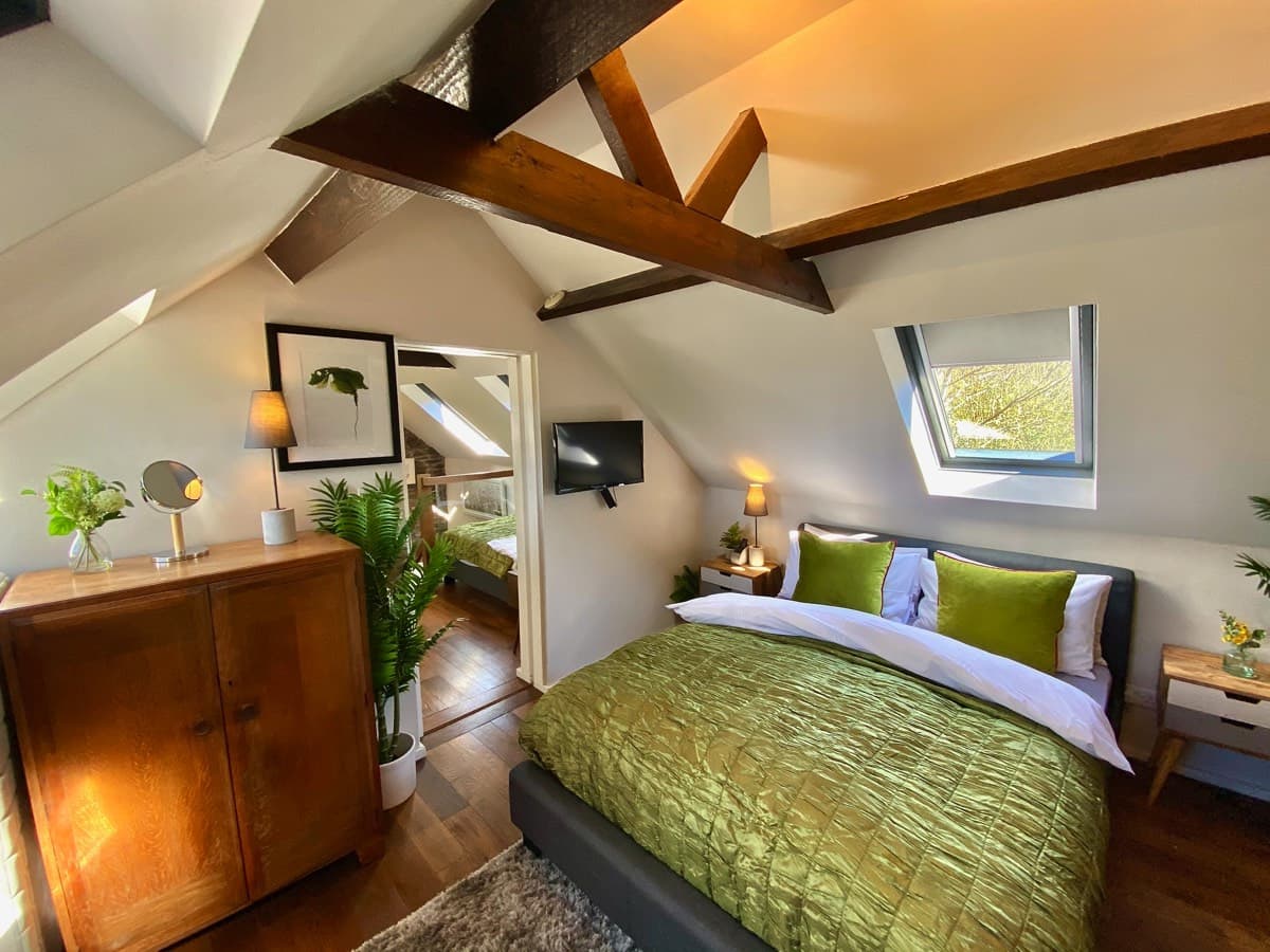 A spacious and comfortable master bedroom with a king-size bed and stunning views of the surrounding countryside