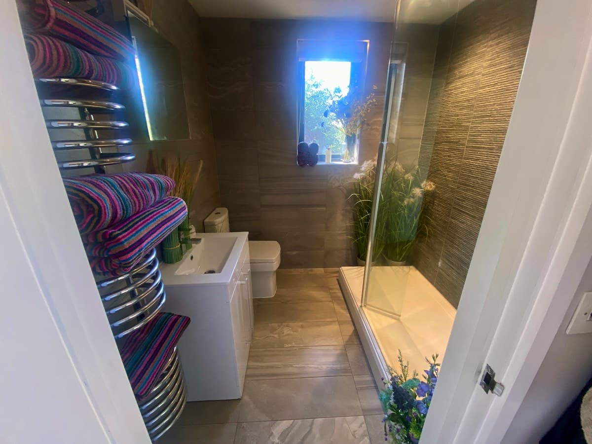 Modern bathroom interior in Devon treehouse with a sleek shower.